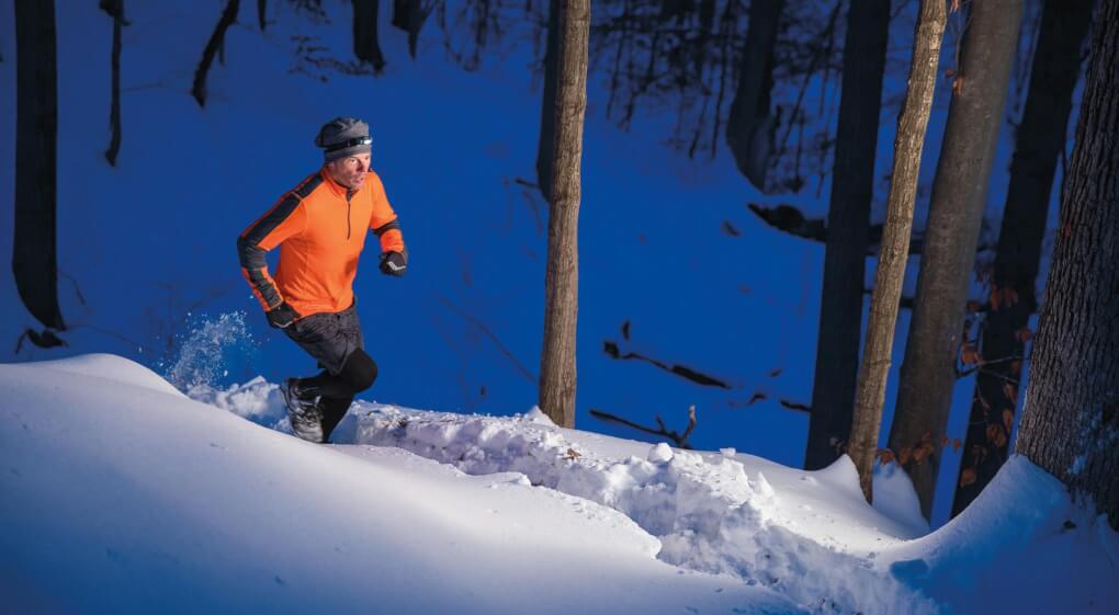 Scott Whisler running on a snowy trail.